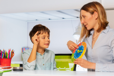 photo of a child with autism reading clock