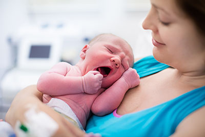 photo of mother holding newborn at the hospital