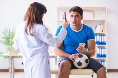 photo of doctor evaluating concussion student