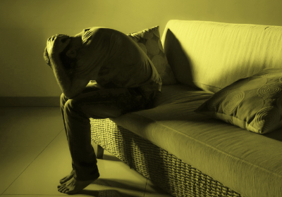 photo of man upset on couch