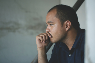 photo of man with hand over mouth with anxiety