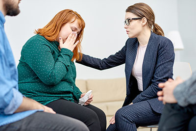 Photo of a woman with an eating disorder being consoled by a counselor