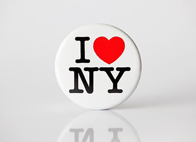 circle pin that says I heart New York