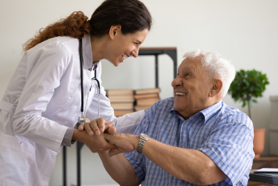 photo of elderly man and doctor laughing