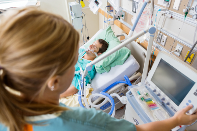 photo of nurse caring for patient in critical care unit