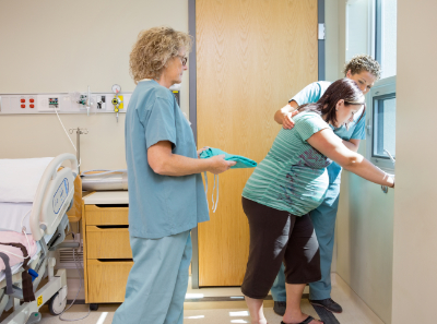 photo of labor and delivery nurses helping a new mother