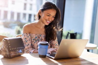 photo of a filipino female smiling and working on computer