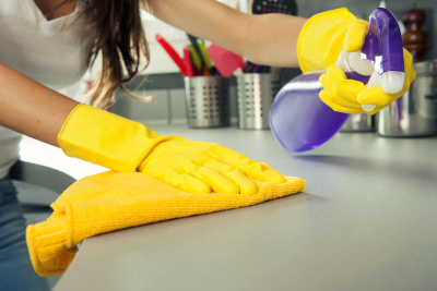 woman cleaning kitchen counter