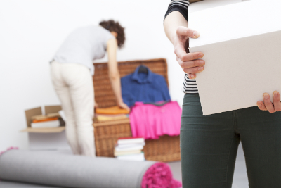 two women organizing and cleaning living room