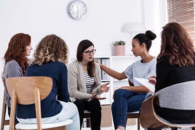 Photo of women sitting together in a group